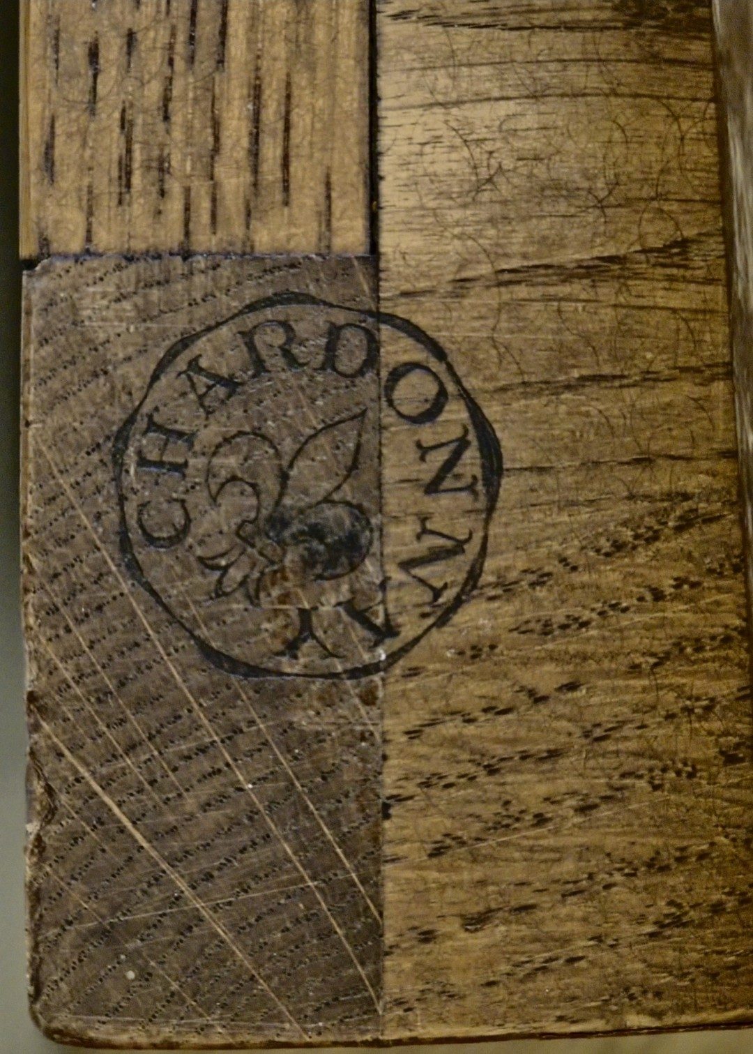 Close-up of CHARDONNAY circular estampille with fleur-de-lys centre, stamped into oak carcase